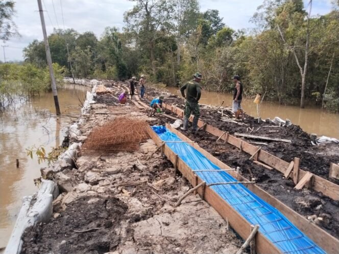 
TNI dan Masyarakat Bersama Pasang Begisting Jalan Desa Talio